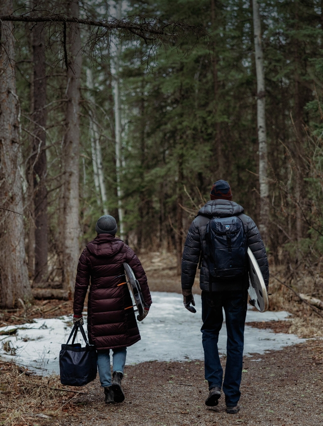 a group of friends on a porch wearing KÜHL clothing.