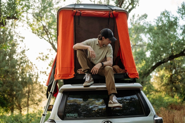 A man walking and wearing Kühl clothes.
